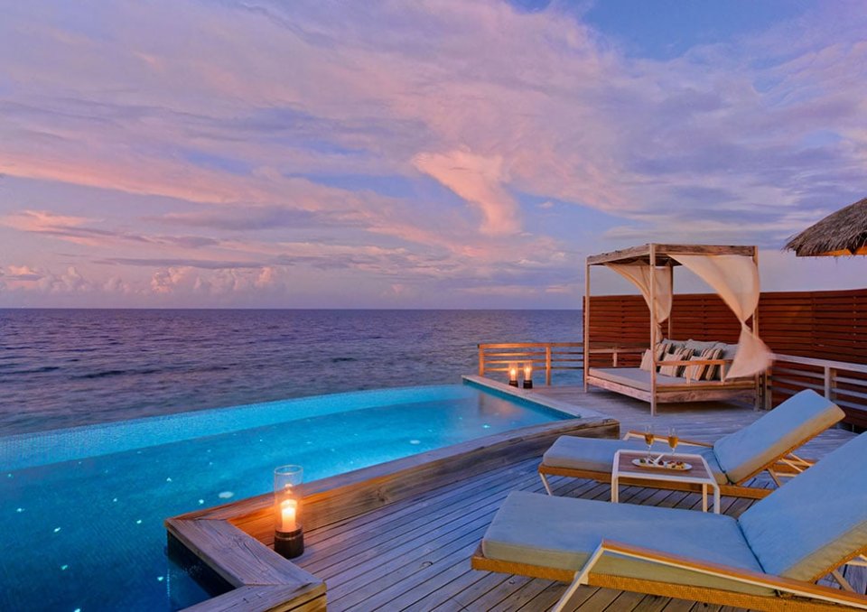 Private pool and daybed at dusk