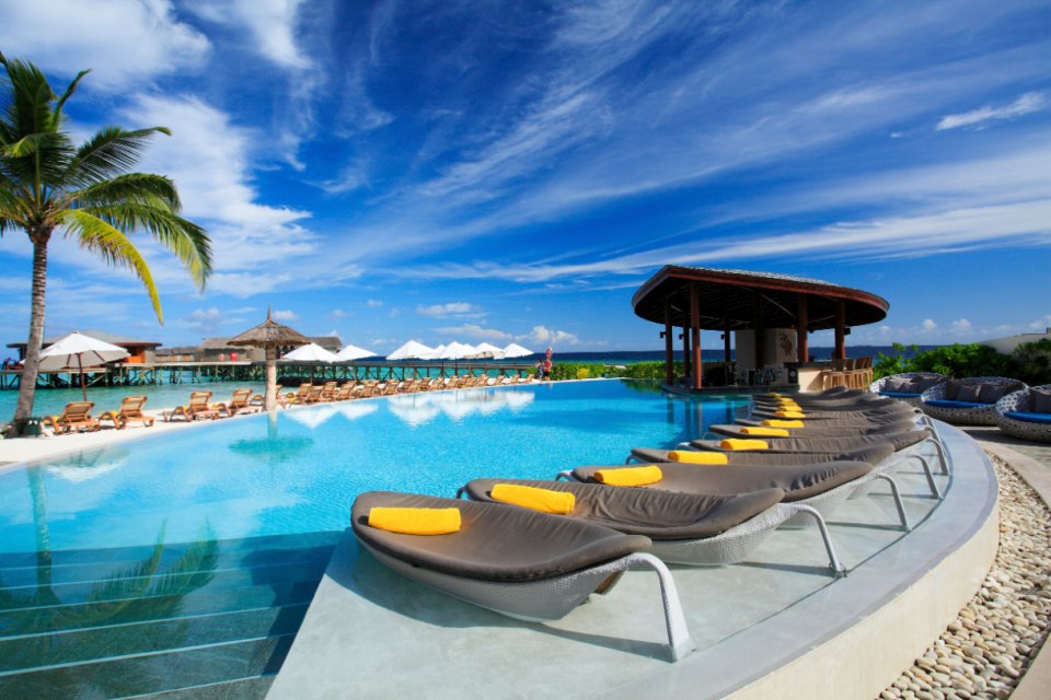 Pool loungers and overwater pavilion