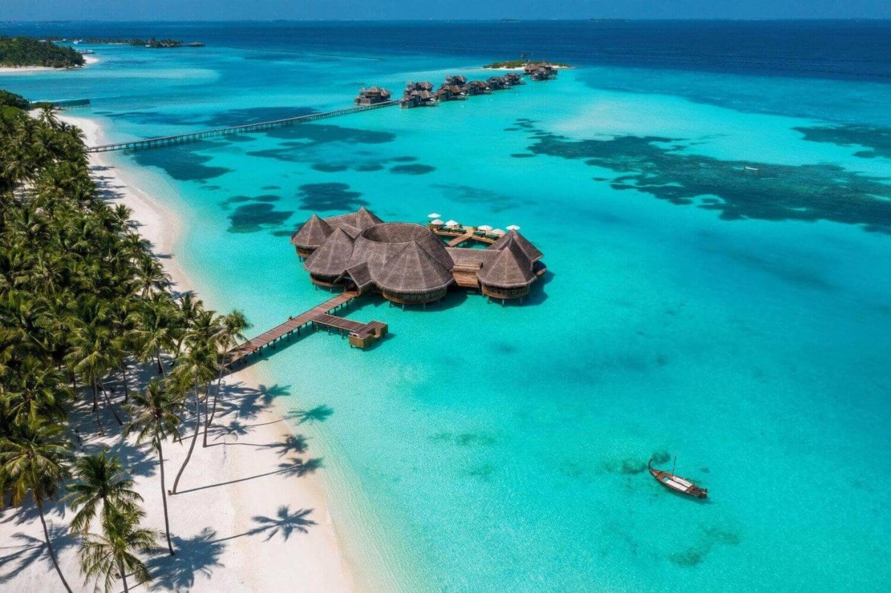 Aerial view of the beach and an overwater villa