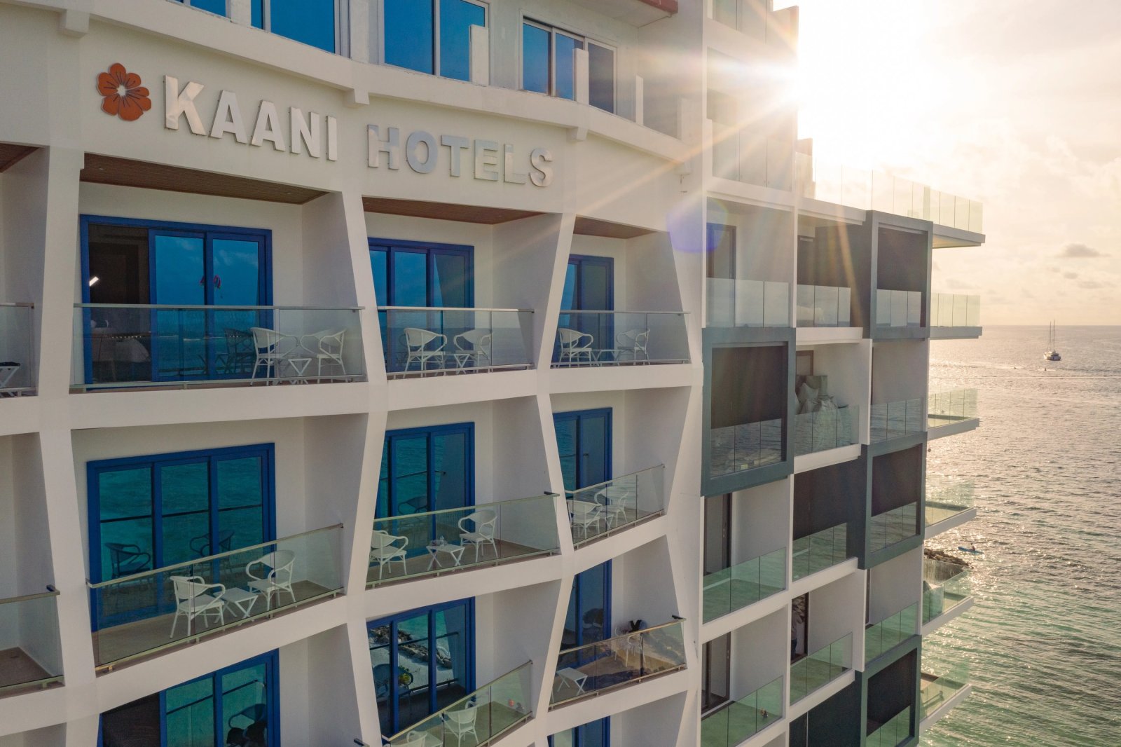 Kaani Palm Beach facade at sunset with ocean balconies