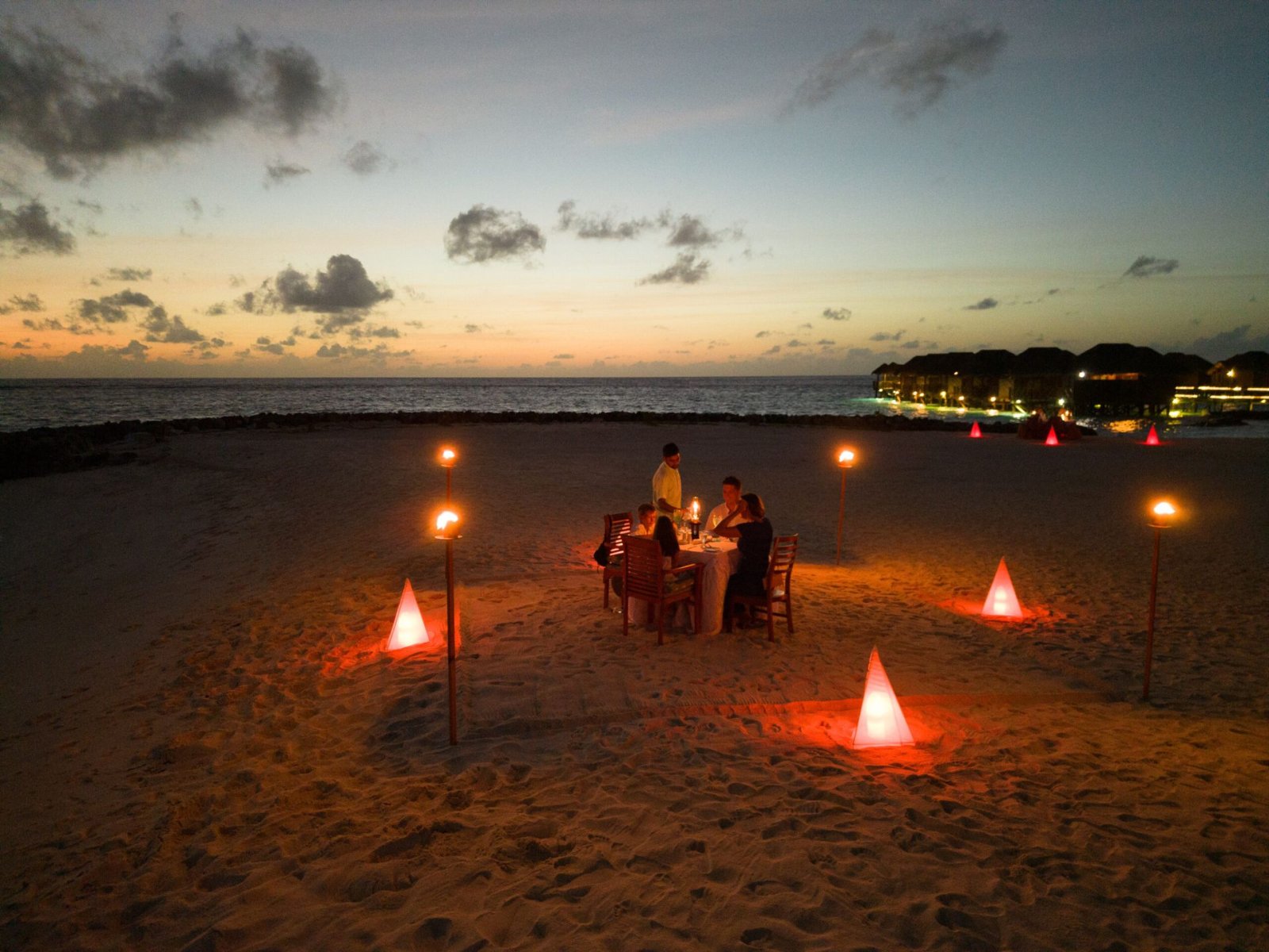 Candlelit beach dinner at dusk