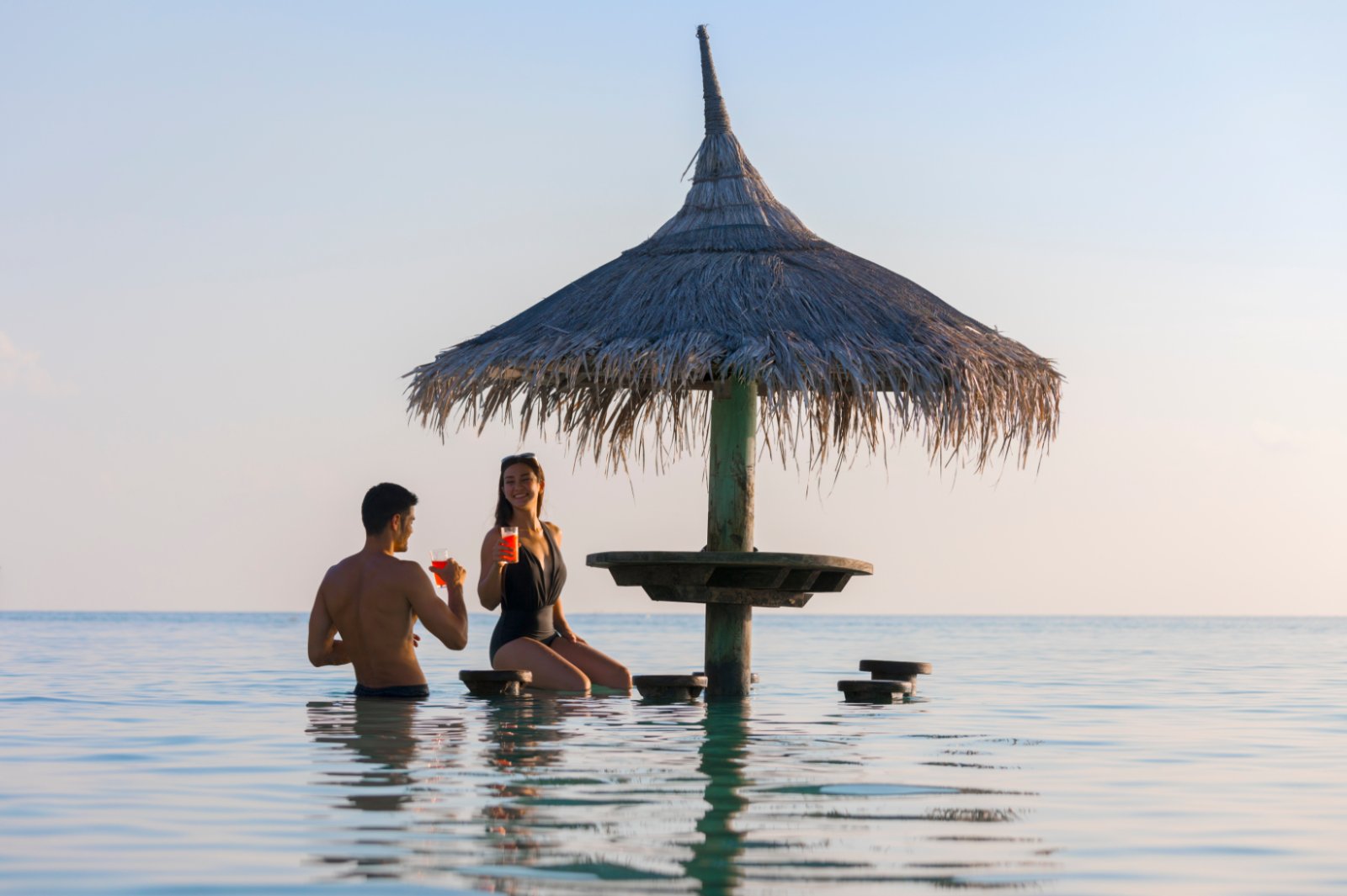 Guests with drinks at an in-water bar