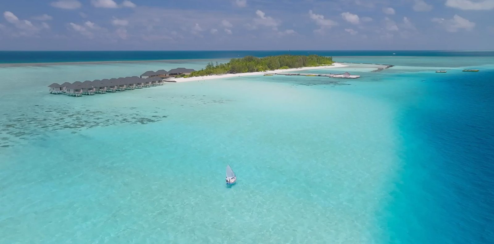 Aerial view of the island and its overwater villas
