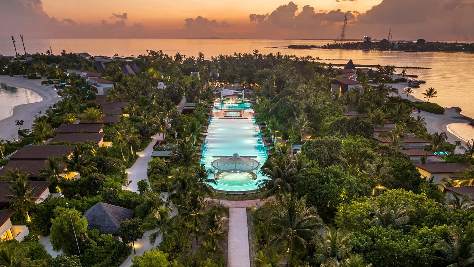 Aerial view of the resort's long pool at dusk