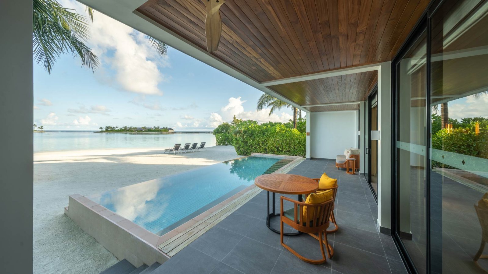 Villa terrace with infinity pool overlooking the lagoon