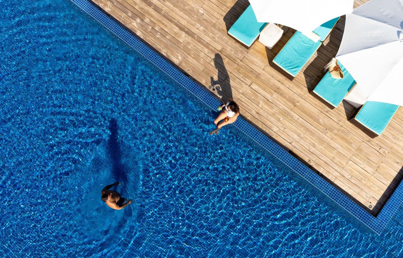 Swimmer in the pool seen from above