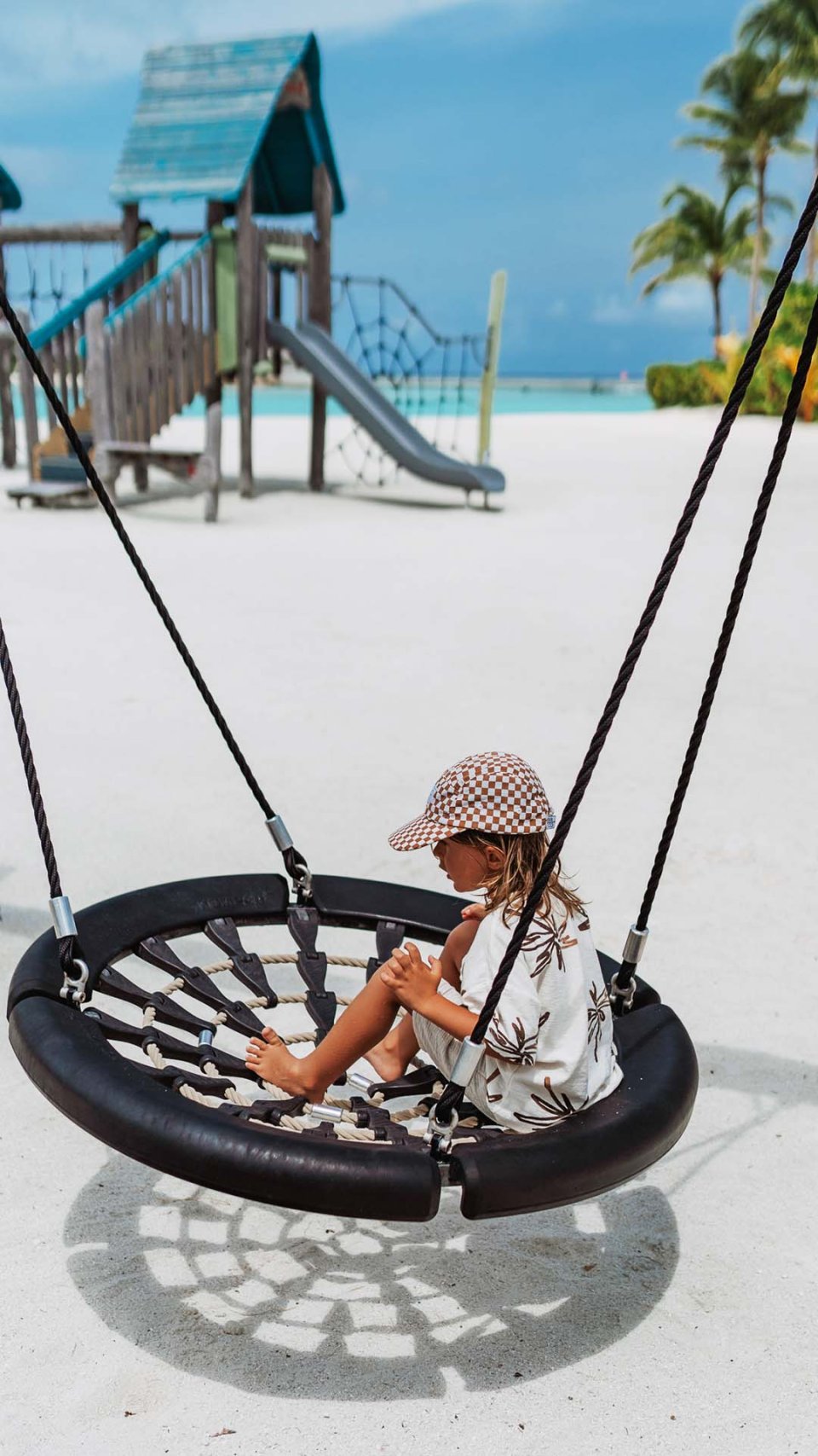 Child on a swing at the outdoor playground