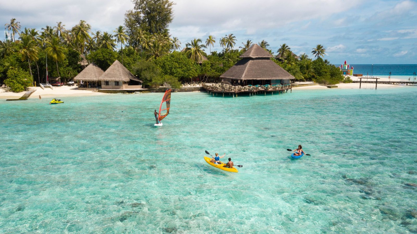 Guests kayaking off the beach