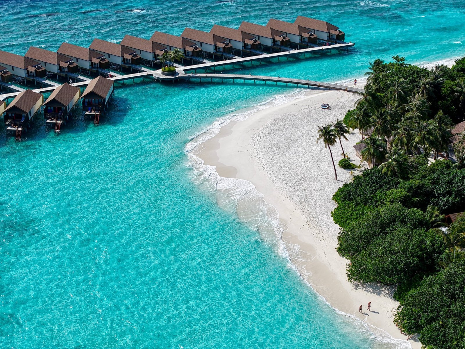 Water villas and white sand beach from above
