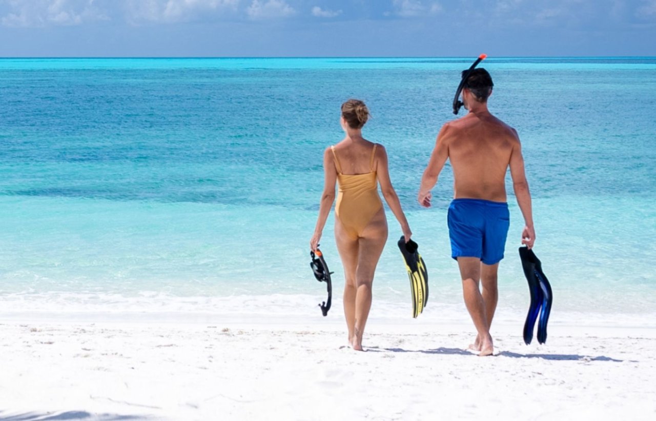 Walking on the beach with snorkelling gear