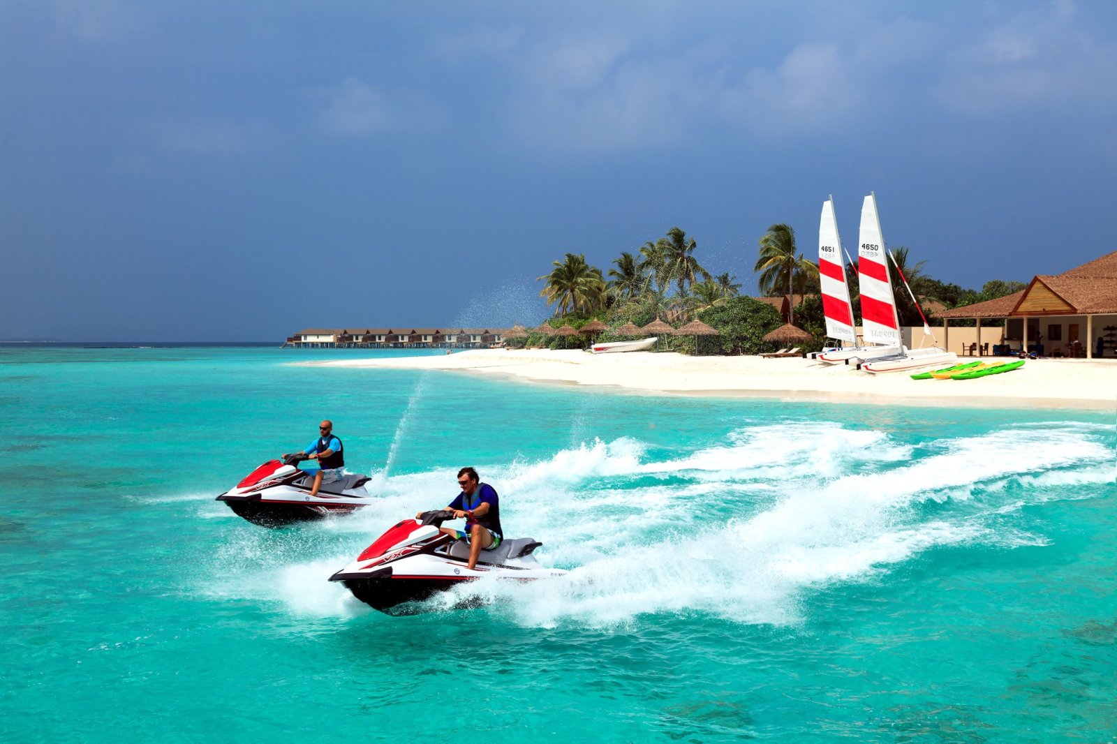 Jet skis and sailing catamarans on the lagoon