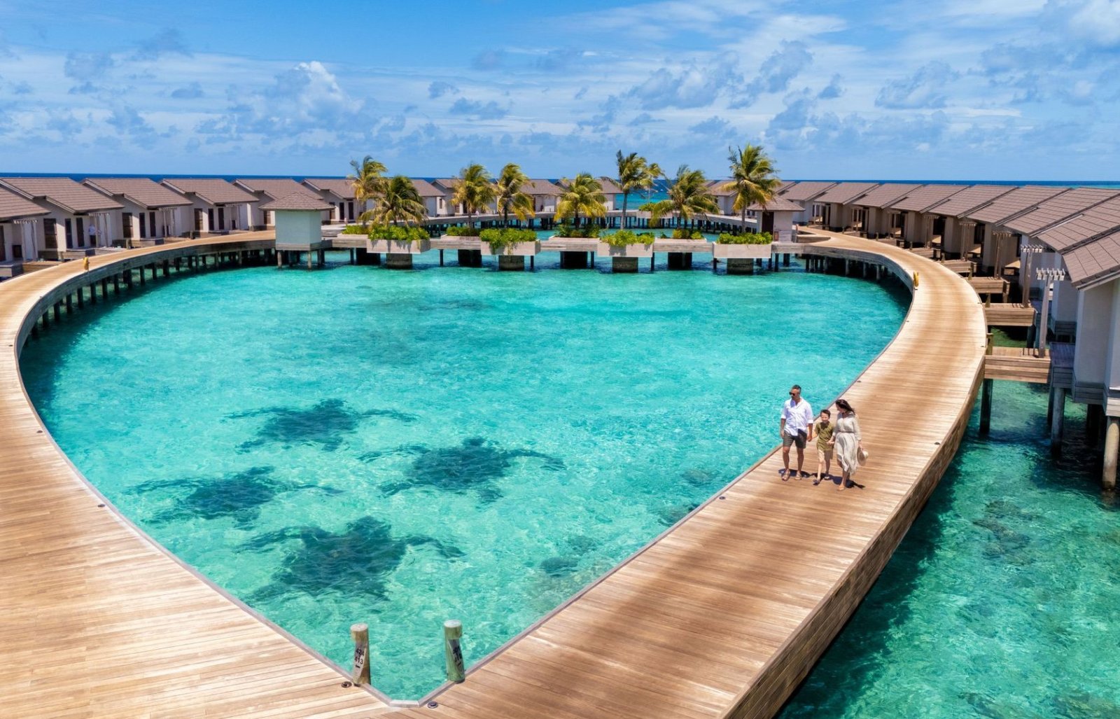 Heart-shaped jetty and overwater villas from above