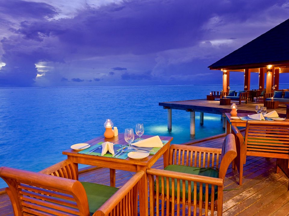 Overwater dining terrace at dusk