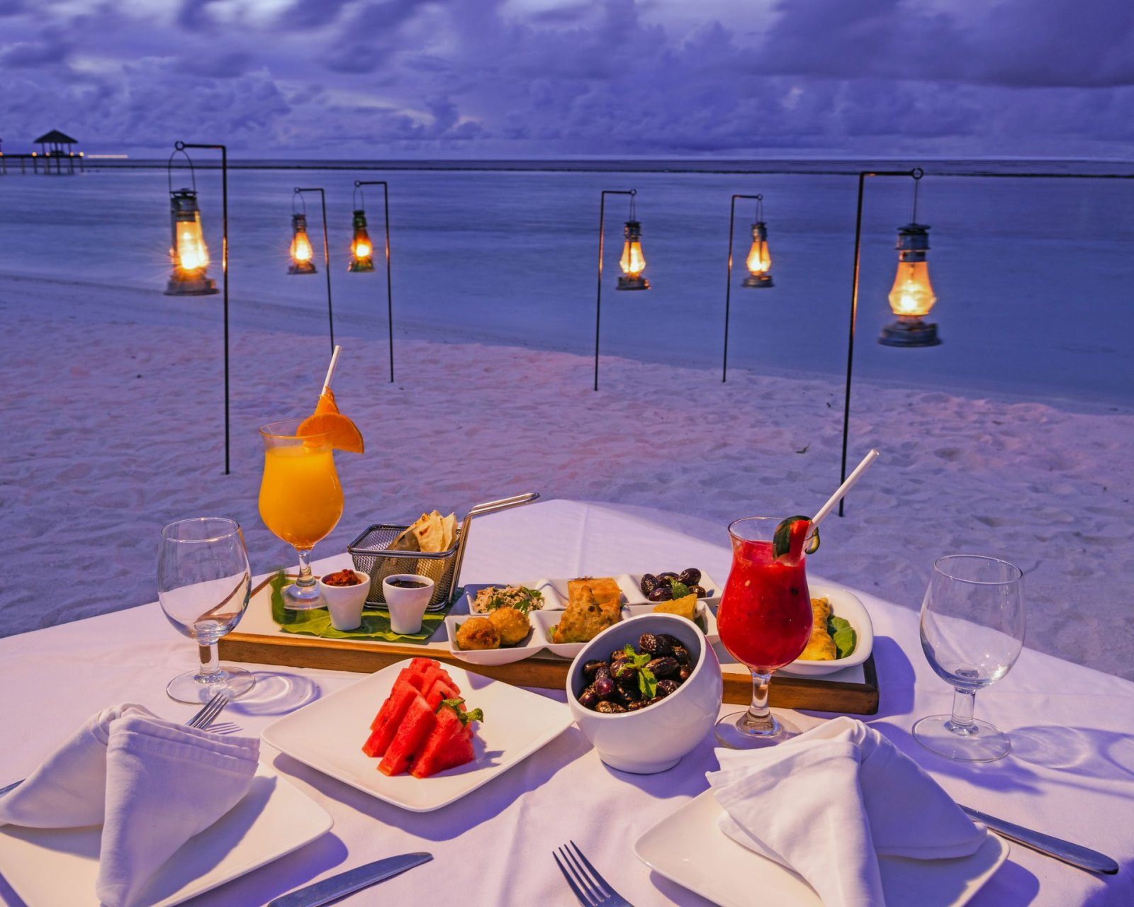 Beach dining set-up with cocktails