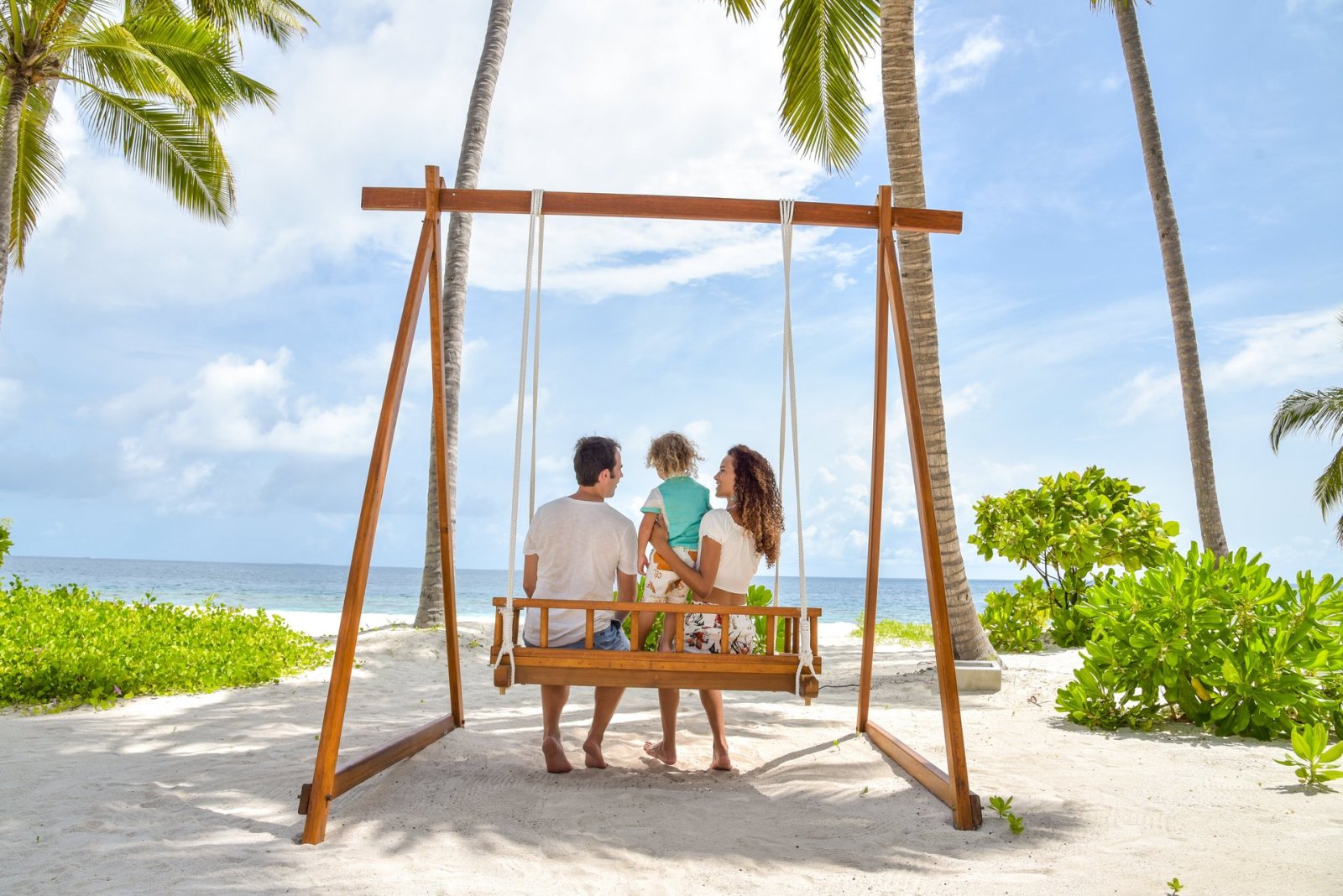 Family on a beach swing