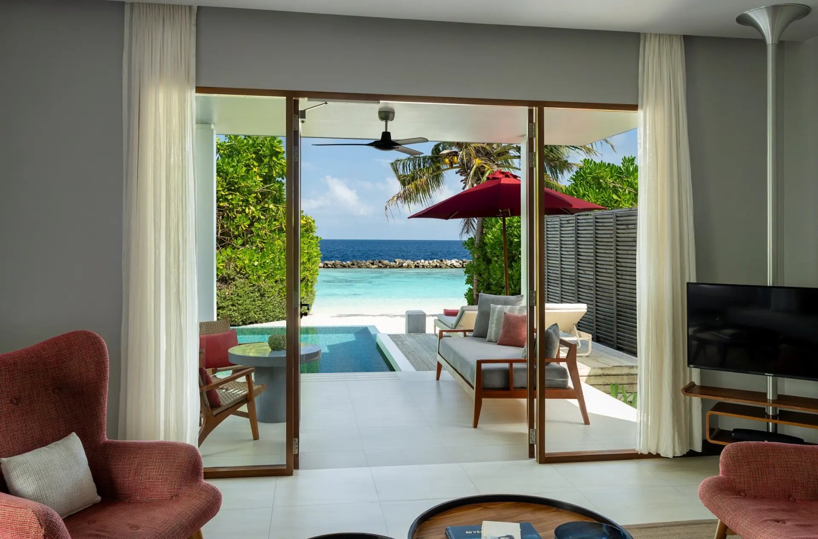 Living room opening to the pool